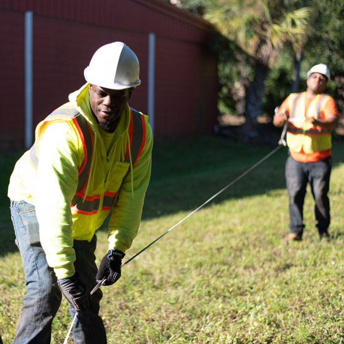 Fiber service image of workers holding a fiber cable
